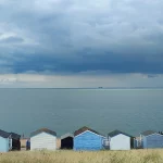 View out to sea from behind the beach huts at Long Rock